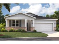 Charming single-story home with stone accents, a two-car garage, and a beautifully landscaped front yard at 4136 Lavender Ct, Lake Hamilton, FL 33851