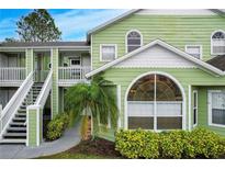 Charming condo building with light green exterior and white trim at 8719 Rockingham Ter # B, Kissimmee, FL 34747