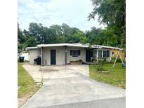 Charming single-story home with concrete driveway and mature trees at 1181 Partlow Dr, Winter Garden, FL 34787