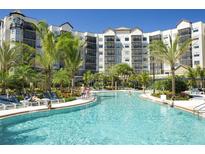 Enjoy the large outdoor pool with palm trees and plenty of lounge chairs at 14501 Grove Resort Ave # 3737, Winter Garden, FL 34787