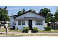 Charming one-story home featuring a black door, black roof and white exterior at 161 Bolender Rd, Auburndale, FL 33823