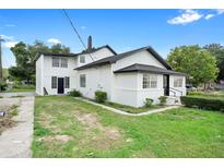 Rear exterior view of a two-story home with a large yard, showcasing the architectural details at 161 Bolender Rd, Auburndale, FL 33823