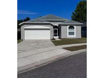 Charming single-story home featuring a two-car garage, neutral paint, and well-maintained landscaping at 2049 Crosscreek Ct, Oviedo, FL 32766