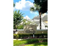 Community sign for Tradewinds A Metrowest Condominium features well-maintained landscaping and a clear, attractive display at 1057 S Hiawassee Rd # 1913, Orlando, FL 32835