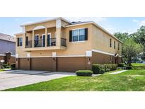 Inviting townhouse with a well-kept lawn and multiple car garage for parking at 2193 Betsy Ross Ln, St Cloud, FL 34769
