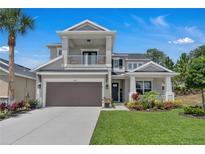 Charming two-story home showcasing a gray exterior, manicured lawn and complemented by a two-car garage at 2845 High Pointe St, Clermont, FL 34711