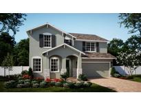 Charming two-story home features a manicured lawn, neutral paint, stone accents, and a two-car garage at 344 Switchgrass Loop, Minneola, FL 34715