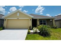 Charming single Gathering home featuring an attached two car garage and well manicured lawn at 4326 Sagefield Dr, Harmony, FL 34773