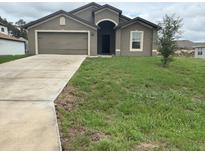 Charming one-story home featuring a two car garage, neutral stucco and a well-maintained front lawn at 1713 Redfin Way, Kissimmee, FL 34759