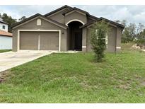 Charming single-Gathering home with a well-maintained lawn and attached two-car garage at 1713 Redfin Way, Kissimmee, FL 34759