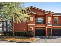 Inviting exterior of a two-story townhome featuring a one-car garage and landscaping at 191 Villa Di Este Ter # 201, Lake Mary, FL 32746