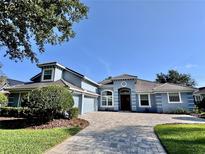 Charming single-story home with a well-manicured front yard, paver driveway, and inviting architectural details at 3225 Regal Crest Dr, Longwood, FL 32779
