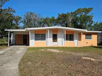 Charming single-story home with a brick facade and attached carport at 3516 Ridgemont Rd, Orlando, FL 32808