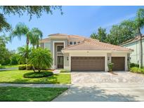 Beautiful two-story home featuring a three-car garage, tile roof, and well-maintained landscaping at 390 Anessa Rose Loop, Ocoee, FL 34761