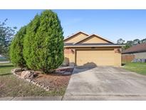 Charming single Gathering home with a well-manicured front yard and a two-car garage at 4102 Boca Woods Dr, Orlando, FL 32826