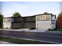 New construction townhomes featuring an attached garage and a combination of gray siding and white trim at 4297 Ranch House Rd, St Cloud, FL 34772