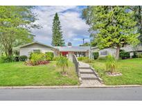 Charming single-story home with a well-manicured lawn and landscaped garden, enhancing its curb appeal at 604 Ponca Trl, Maitland, FL 32751