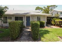 Charming single-story home featuring well-maintained landscaping and a quaint blue front door at 610 Heatherton Vlg # 610, Altamonte Springs, FL 32714