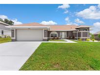 Charming single-story home featuring a well-maintained lawn and a two-car garage at 801 Hunt Dr, Lake Wales, FL 33853