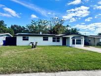 Charming single-story home with fresh exterior paint and a well-manicured lawn on a sunny day at 804 Starke Lake Cir, Ocoee, FL 34761