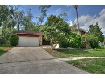 Charming single-story home with a stone facade, mature trees, and a well-maintained front yard at 916 Great Bend Rd, Altamonte Springs, FL 32714