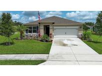 Beautiful single-Gathering home featuring a well manicured lawn and a two-car garage at 1313 Middle Lake Dr, Ormond Beach, FL 32174
