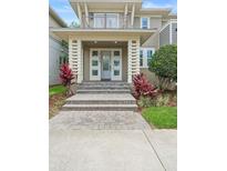 Charming home with a welcoming front door and well-manicured landscaping and brick steps at 14126 Walcott Ave, Orlando, FL 32827