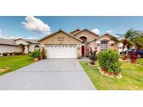 Charming one-story home with well-manicured lawn, mature landscaping, and a two-car garage at 2506 Shelby Cir, Kissimmee, FL 34743