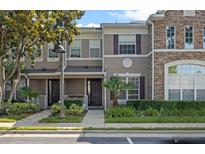 Charming townhome featuring a well-maintained lawn and appealing architectural details at 461 Black Knight Way, Longwood, FL 32779