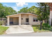 Charming single-story home features a carport and well-maintained landscaping at 1111 Liberty Ave, Mount Dora, FL 32757
