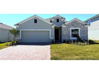 Charming single-story home featuring stone accents, a two-car garage, and a well-maintained front lawn at 131 Addle Hill Ct, Deland, FL 32720