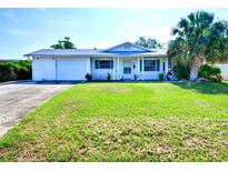 Charming single-story home features a well-manicured front lawn, attached garage, and classic curb appeal at 1670 Clematis Ln, Winter Park, FL 32792