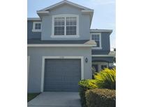 Two-story home showing garage, updated landscaping, and modern paint scheme at 1754 Fritwell Ct, Ocoee, FL 34761