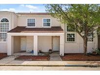 Charming two-story townhouse featuring a covered front porch and well-maintained landscaping at 214 Majors Ln # C, Kissimmee, FL 34743