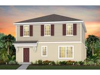 Charming two-story home with tan siding, dark shutters and a welcoming front porch at 3324 Orange Rose Loop, Apopka, FL 32712