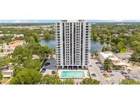 Stunning aerial view of Park Lake Towers featuring a pool, beautiful lake, and picturesque surroundings at 400 E Colonial Dr # 207, Orlando, FL 32803