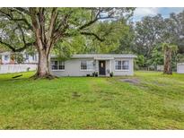 Charming single-story home with a well-maintained lawn and mature trees offering shade at 405 Willow Ave, Sanford, FL 32771