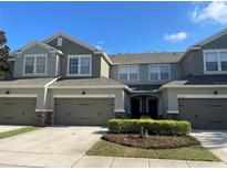 Charming townhome with a well-maintained lawn, two car garage, and neutral gray color scheme at 8608 Falstaff Pl, Oviedo, FL 32765