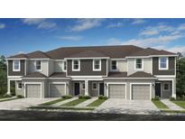 Charming townhome boasts modern architecture, attached garages, and tidy landscaping under a bright blue sky at 130 River Front Way, Edgewater, FL 32141