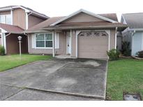 Charming one-story home with a well-maintained front yard, concrete driveway, and single-car garage at 1827 Blaine Ter, Winter Park, FL 32792