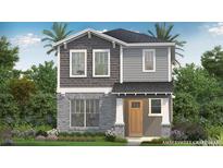 Charming two-story home featuring stone accents, gray siding, and a welcoming front porch at 2034 Education St, St Cloud, FL 34771