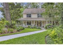 Charming two-story home featuring a manicured front yard and inviting front porch at 2132 Palm Vista Dr, Apopka, FL 32712