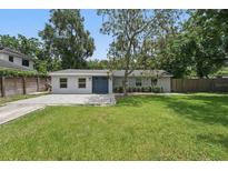 Charming single-story home with a well-maintained lawn, beautiful pavers, and a striking blue double-door entrance at 240 Cambridge Blvd, Winter Park, FL 32789