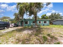 Charming single-story home with a covered carport, front yard, and mature tree at 240 W Grossenbacher Dr, Apopka, FL 32712