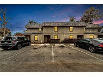 Two-story condo building with dedicated parking spaces and simple landscaping at 2826 Ne 7Th St, Ocala, FL 34470