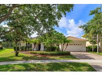 Charming single-story home featuring a tile roof, manicured landscaping, and a two-car garage at 4034 Bougainvillea Pl, Kissimmee, FL 34746