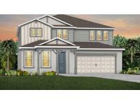 Charming two-story home featuring a two-car garage, stylish siding, and well-manicured lawn at 4116 Winding Pines Dr, Apopka, FL 32712