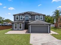 Beautiful two-story home with a spacious driveway, solar panels, and well-maintained landscaping at 470 Regal Downs Cir, Winter Garden, FL 34787