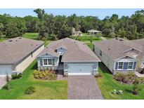Beautiful one-story home with well-maintained landscaping, paver driveway, and attached two-car garage at 1580 Delphi Way, New Smyrna Beach, FL 32168