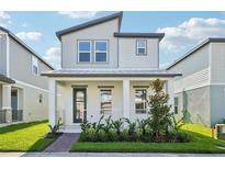 Charming two-story home with modern design, a cozy front porch, and well-manicured landscaping at 16454 Silver Brook Way, Winter Garden, FL 34787